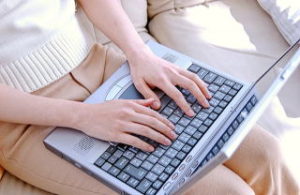 パソコンでブログを更新している女性